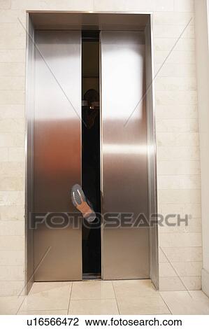 Waiter's foot blocking elevator doors View Large Photo Image Stock Image - Waiter's foot blocking elevator doors. Fotosearch