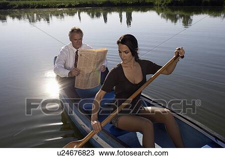 Young woman and businessman in canoe. View Large Photo Image Stock Image - Young woman and businessman in canoe.. Fotosearch
