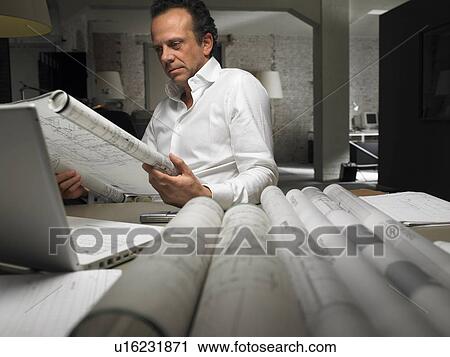 Architect reading a blueprint. Brussels, Belgium. View Large Photo Image Stock Image - Architect reading a blueprint. Brussels, Belgium.. Fotosearch