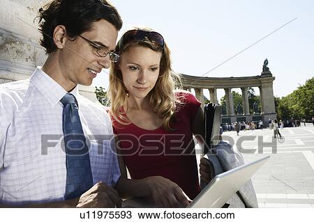 Businessman and businesswoman outdoors with a laptop. View Large Photo Image Stock Image - Businessman and businesswoman outdoors with a laptop.. Fotosearch