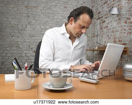 Businessman working on laptop., Brussels, Belgium. View Large Photo Image Stock Image - Businessman working on laptop., Brussels, Belgium.. Fotosearch