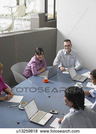 Businesspeople in a meeting View Large Photo Image Stock Photo - Businesspeople in a meeting. Fotosearch