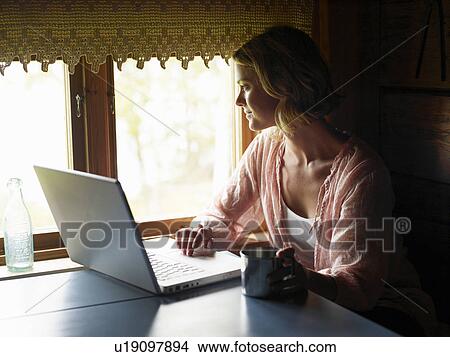 Picture - Businesswoman working from home. Fotosearch