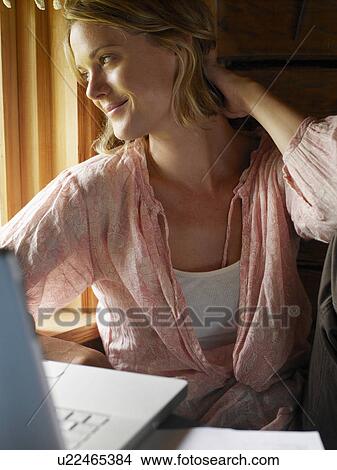 Picture - Businesswoman working from home. Fotosearch