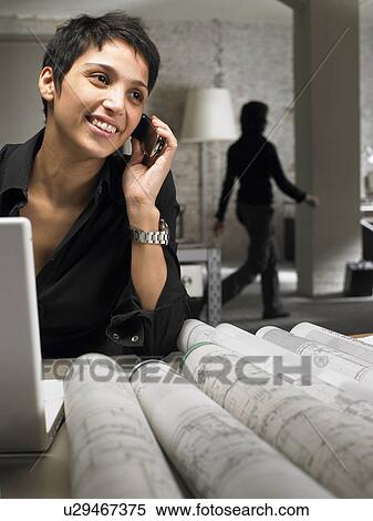 Female architect talking on phone. Woman walking in background. Brussels, Belgium. View Large Photo Image Stock Photography - Female architect talking on phone. Woman walking in background. Brussels, Belgium.. Fotosearch