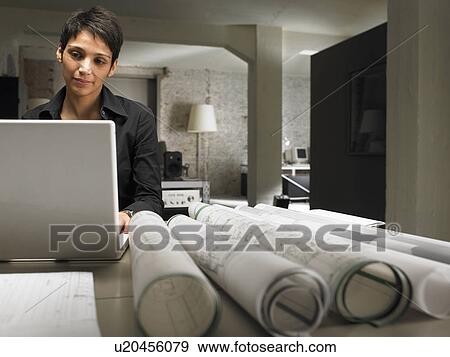 Female architect working on laptop. Brussels, Belgium. View Large Photo Image Stock Photo - Female architect working on laptop. Brussels, Belgium.. Fotosearch