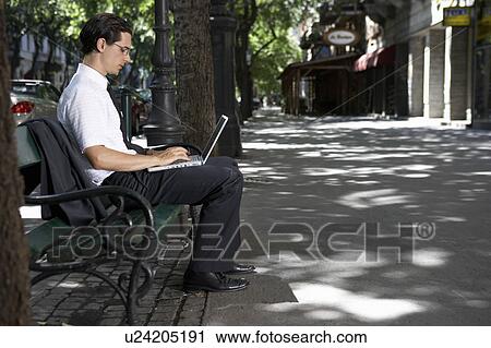 Man working on bench with laptop. View Large Photo Image Stock Image - Man working on bench with laptop.. Fotosearch