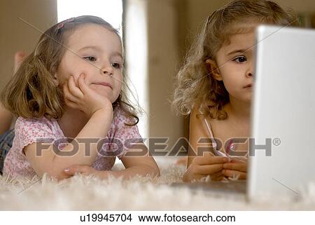 Picture - Two girls (2-4) using laptop.. Fotosearch