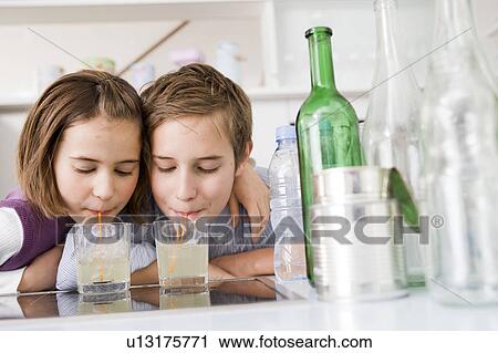 Boy and girl drinking lemonade View Large Photo Image Stock Image - Boy and girl drinking lemonade. Fotosearch