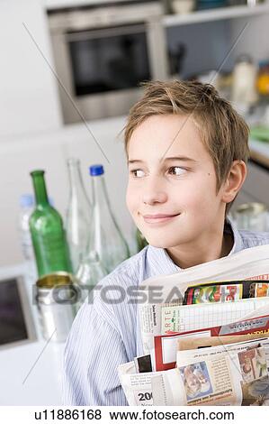 Stock Photo - Boy carrying waste paper. Fotosearch