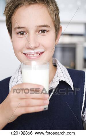 Boy drinking a glass of milk View Large Photo Image Stock Photograph - Boy drinking a glass of milk. Fotosearch