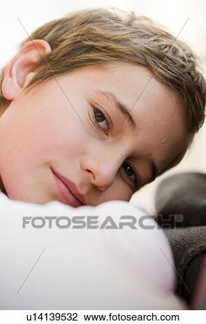 Stock Image - Boy looking into camera. Fotosearch