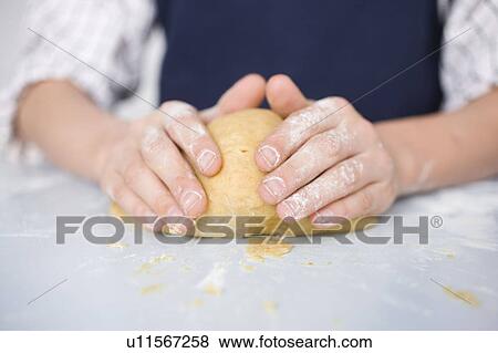 Stock Photo - Boy preparing dough. Fotosearch