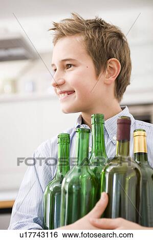 Boy recycling empty bottles View Large Photo Image Stock Photograph - Boy recycling empty bottles. Fotosearch