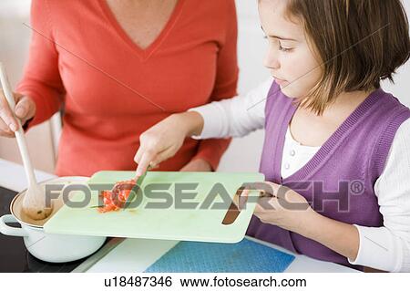 Daughter and mother cooking View Large Photo Image Stock Photograph - Daughter and mother cooking. Fotosearch