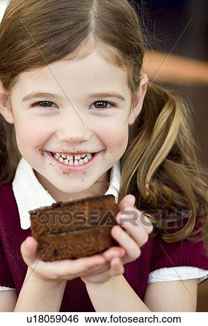 Stock Photograph - Girl holding an chocolate cake. Fotosearch