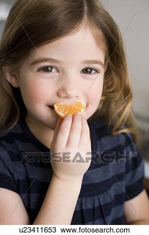 Girl holding tangerine View Large Photo Image Stock Image - Girl holding tangerine. Fotosearch