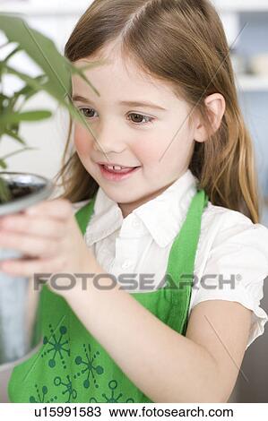Stock Image - Girl looking at herbs. Fotosearch