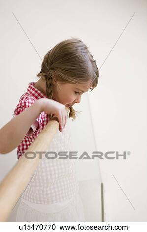 Stock Image - Girl looking down. Fotosearch