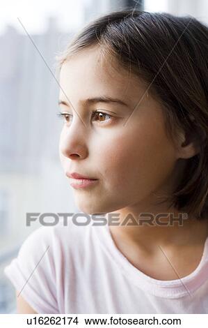 Girl looking out of window View Large Photo Image Picture - Girl looking out of window. Fotosearch