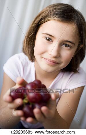 Girl offering grapes View Large Photo Image Stock Photography - Girl offering grapes. Fotosearch