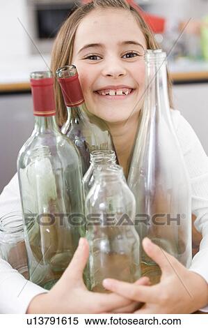 Girl recycling empty bottles View Large Photo Image Stock Photography - Girl recycling empty bottles. Fotosearch