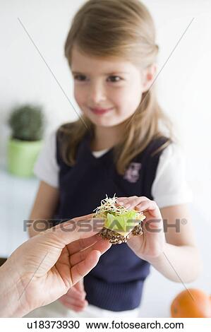 Girl taking bread from mother View Large Photo Image Stock Image - Girl taking bread from mother. Fotosearch
