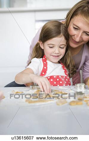 Mother and daughter preparing cookies View Large Photo Image Stock Photo - Mother and daughter preparing cookies. Fotosearch