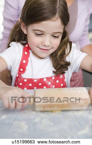 Mother and daughter preparing dough View Large Photo Image Stock Image - Mother and daughter preparing dough. Fotosearch