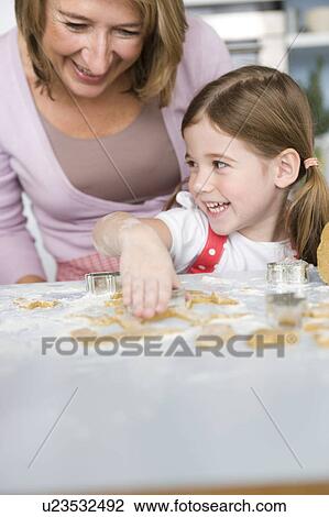 Mother and daughter preparing dough View Large Photo Image Stock Image - Mother and daughter preparing dough. Fotosearch