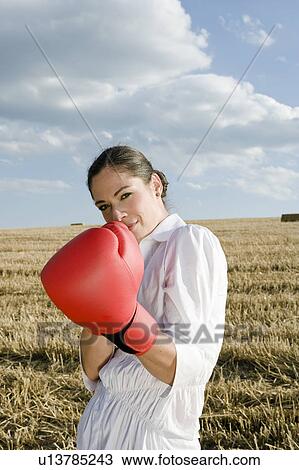 Businesswoman in wheat field wearing boxing gloves. View Large Photo Image Stock Image - Businesswoman in wheat field wearing boxing gloves.. Fotosearch