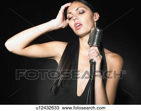 Female singer with microphone elegant black dress portrait. View Large Photo Image Stock Image - Female singer with microphone elegant black dress portrait.. Fotosearch
