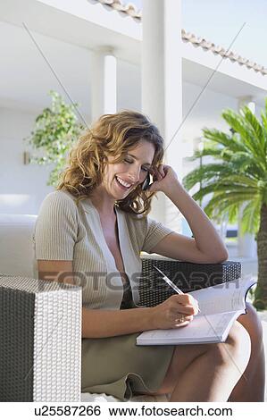 Smiling woman on mobile phone. View Large Photo Image Stock Photograph - Smiling woman on mobile phone.. Fotosearch