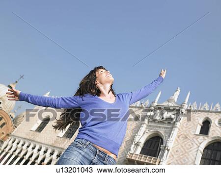 Smiling woman with arms outstretched. Palazzo Ducale, Venice, Italy. View Large Photo Image Stock Image - Smiling woman with arms outstretched. Palazzo Ducale, Venice, Italy.. Fotosearch