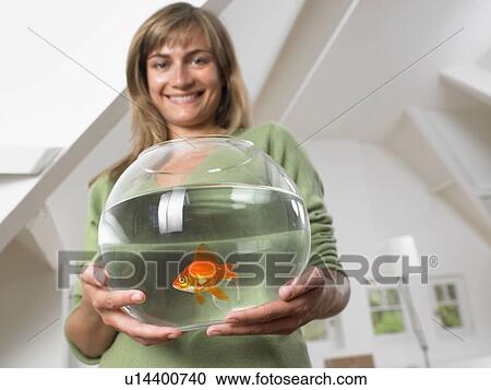 Woman holding fishbowl in new home smiling. View Large Photo Image Stock Image - Woman holding fishbowl in new home smiling.. Fotosearch