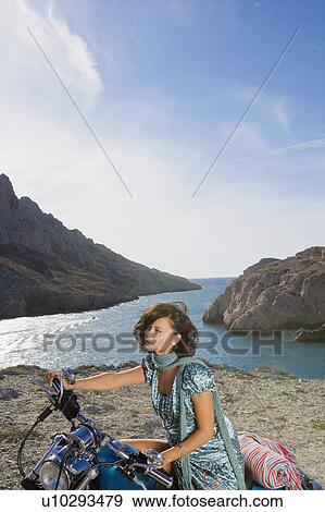 Stock Photo - Woman on motorbike. . Fotosearch