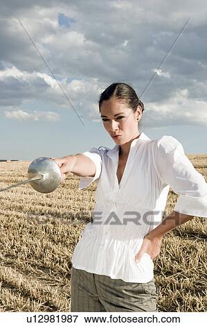 Woman pointing sword in wheat field. View Large Photo Image Stock Photo - Woman pointing sword in wheat field.. Fotosearch