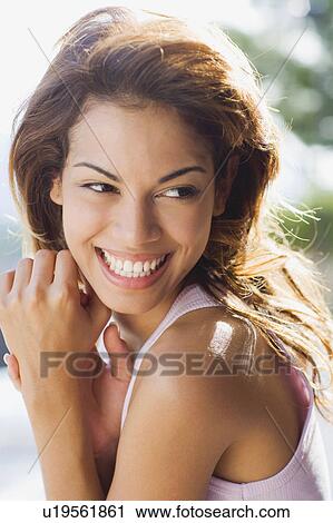 Stock Image - Woman smiling outdoors.. Fotosearch
