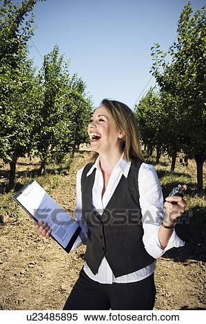 Woman with stopwatch in orchard. View Large Photo Image Stock Photography - Woman with stopwatch in orchard.. Fotosearch