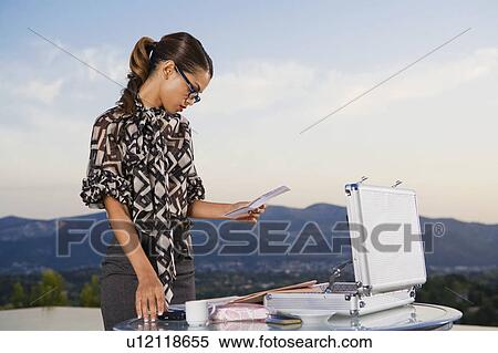 Stock Photography - Woman working at home outdoors.. Fotosearch