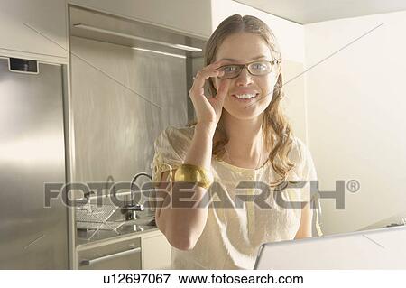 Young business woman working from home kitchen. View Large Photo Image Stock Photo - Young business woman working from home kitchen.. Fotosearch