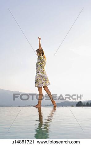 Stock Image - Young woman by poolside.. Fotosearch