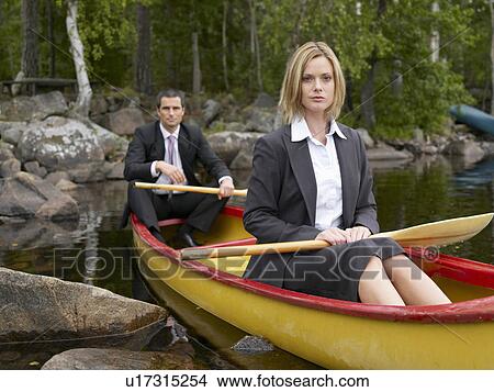 Picture - Business couple in a kayak. Fotosearch