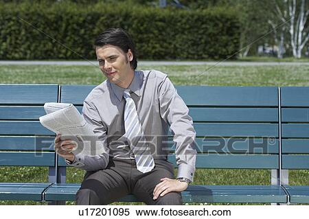 Businessman on bench with newspaper reading. View Large Photo Image Stock Photography - Businessman on bench with newspaper reading.. Fotosearch