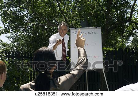 Businesspeople at a rural retreat. View Large Photo Image Stock Image - Businesspeople at a rural retreat.. Fotosearch