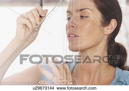 Close-Up portrait of woman through window using graphic drawing equipment. View Large Photo Image Picture - Close-Up portrait of woman through window using graphic drawing equipment.. Fotosearch