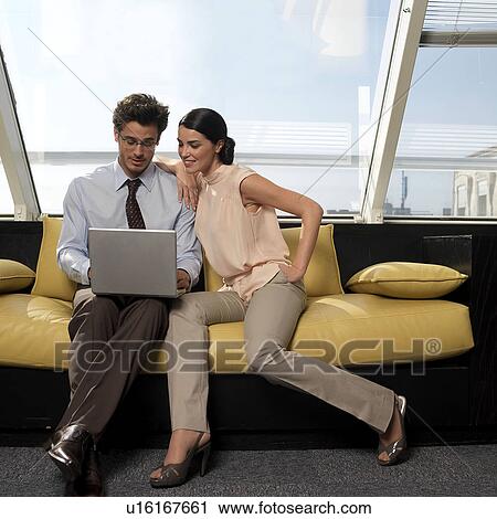 Couple looking at laptop View Large Photo Image Stock Image - Couple looking at laptop. Fotosearch