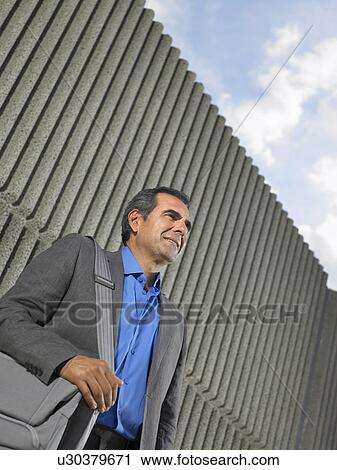 Low angle portrait of older man in suit by textured concrete wall, Alicante, Spain, View Large Photo Image Stock Image - Low angle portrait of older man in suit by textured concrete wall, Alicante, Spain,. Fotosearch
