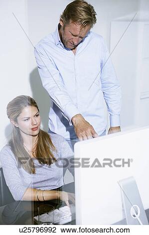 Man and woman in office on computer. View Large Photo Image Stock Image - Man and woman in office on computer.. Fotosearch