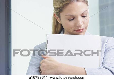 Young Business woman in office with file eyes closed. View Large Photo Image Stock Image - Young Business woman in office with file eyes closed.. Fotosearch